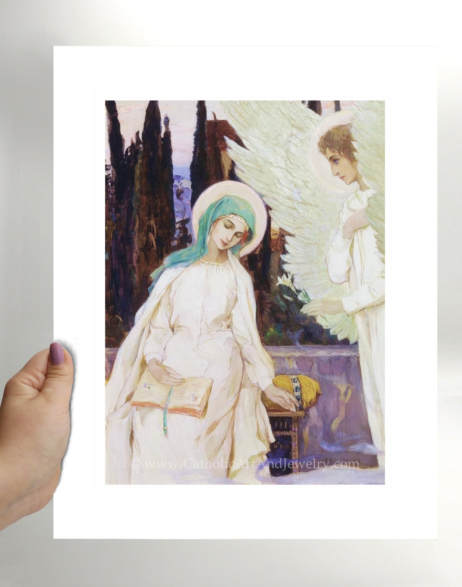 a person holding a picture of an angel