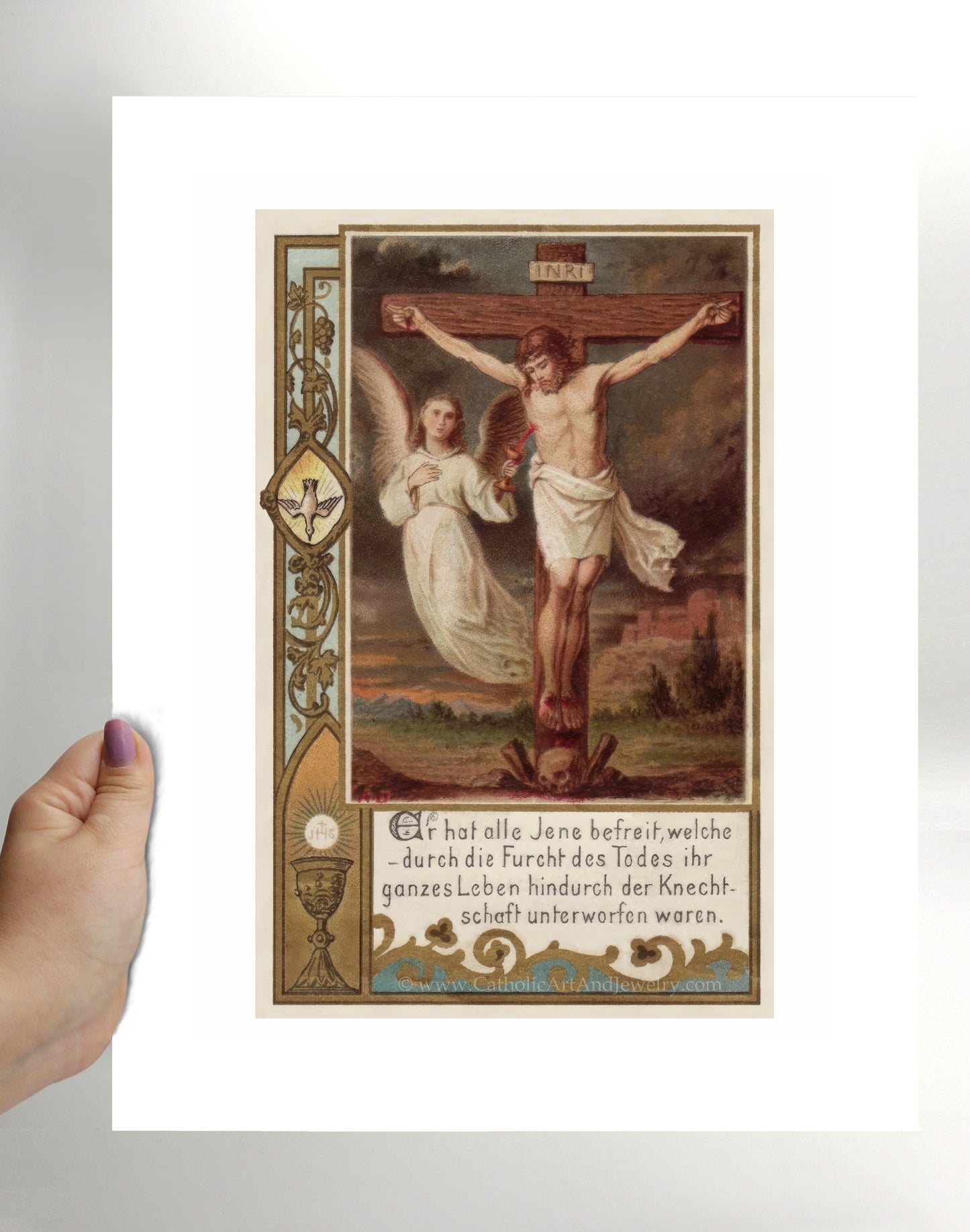 a person holding a card with a painting of jesus on it