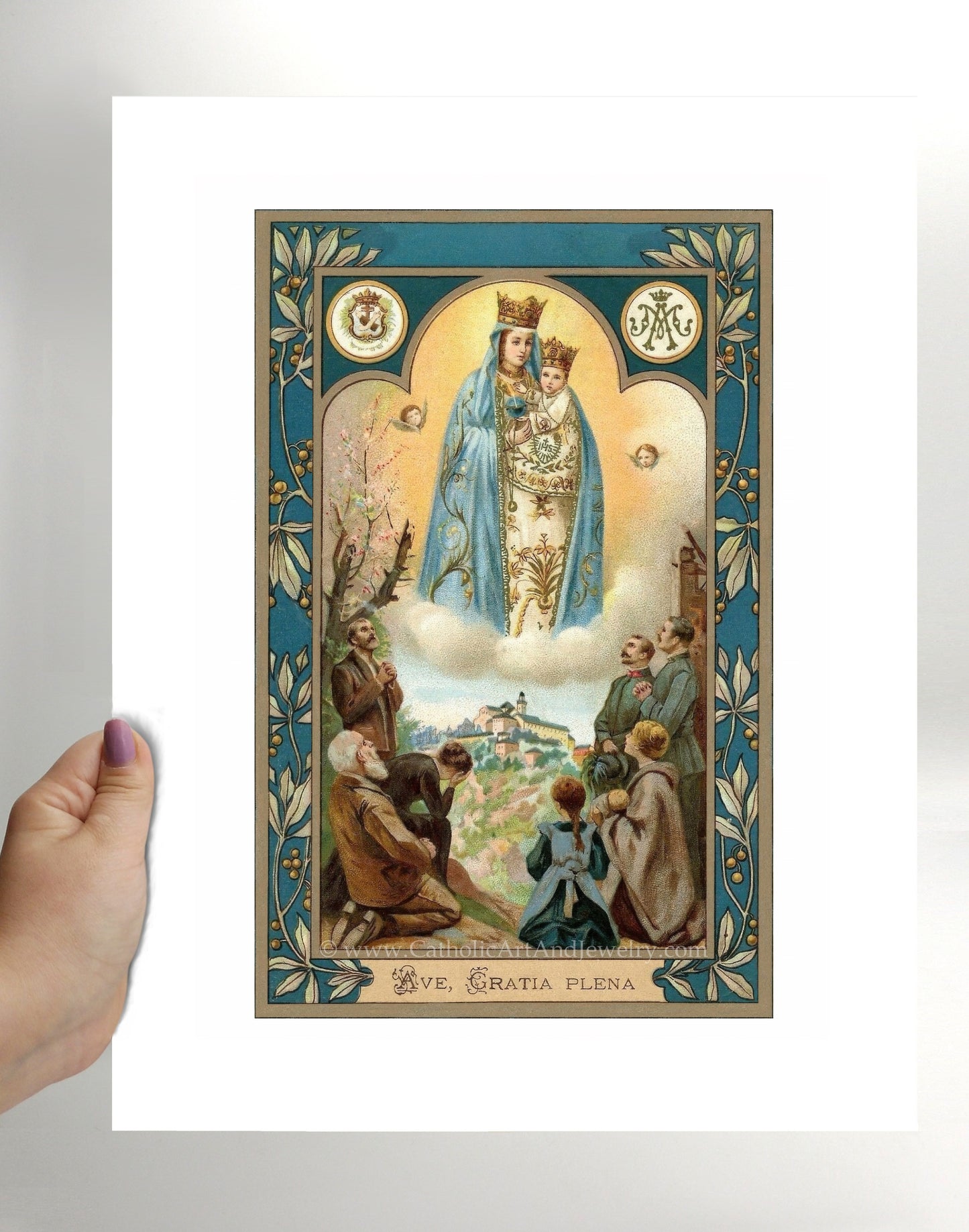 a person holding up a card with an image of the virgin mary