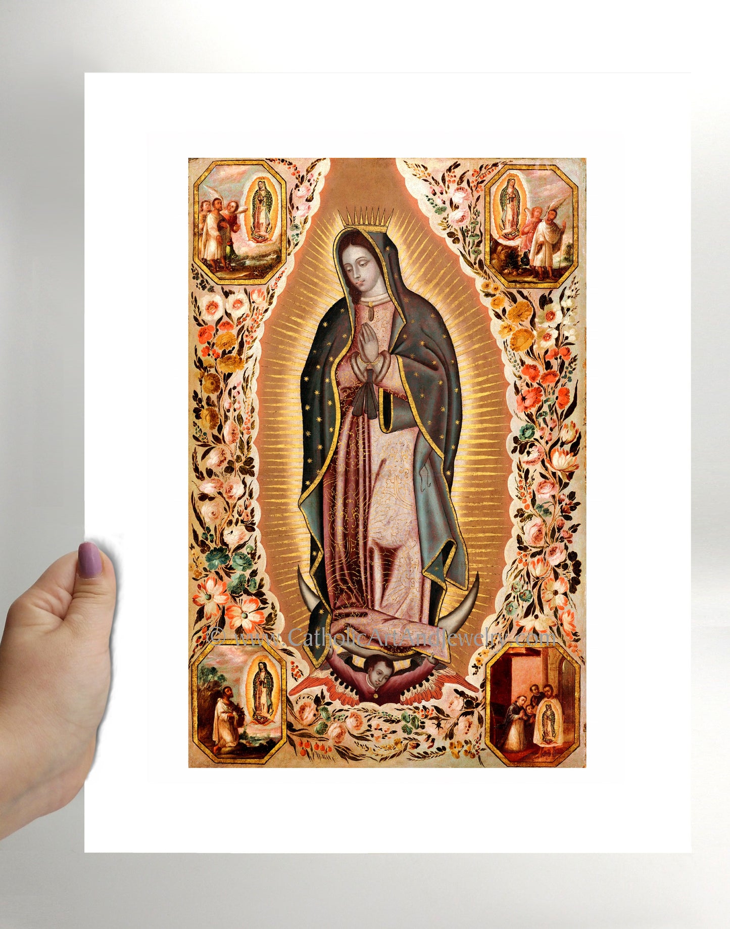 a hand holding up a picture of the virgin mary