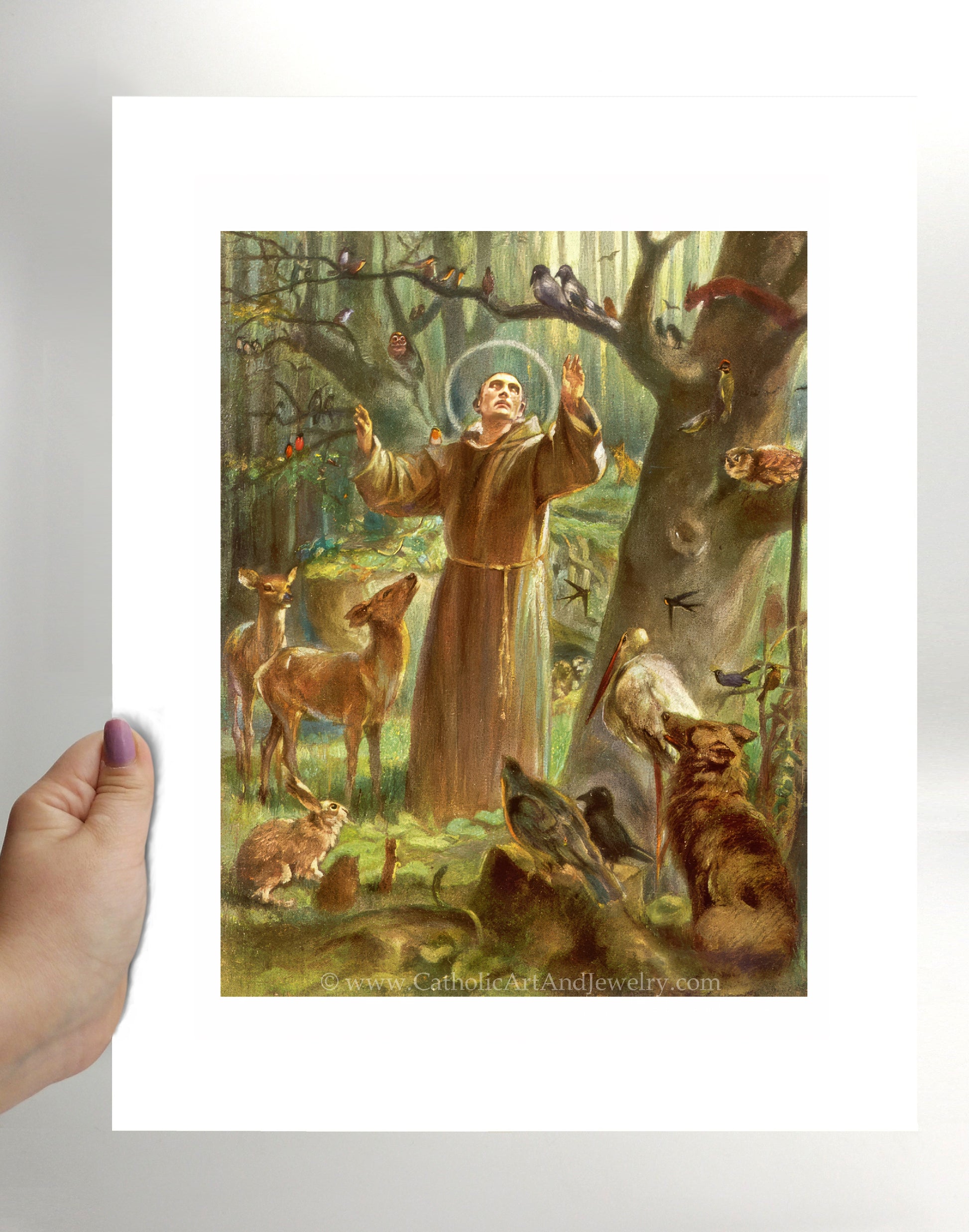 a person holding a card with a painting of a man surrounded by animals