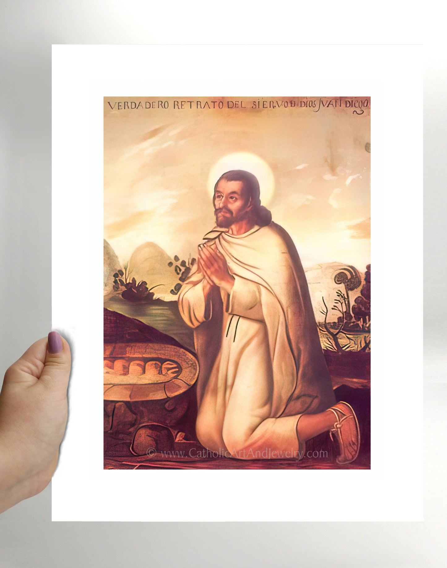 a person holding a picture of jesus in their hand