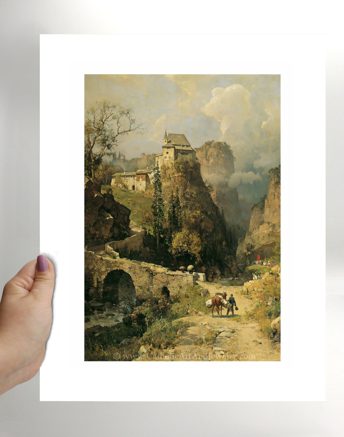 a person holding a picture of a mountain landscape